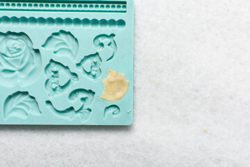 overhead view of vanilla sugar cookie dough in a blue silicone mould, top view of plain vanilla cookie dough in a mold