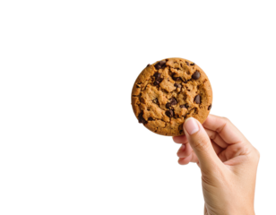 Chocolate chip cookie held in hand isolated on black background on transparent background