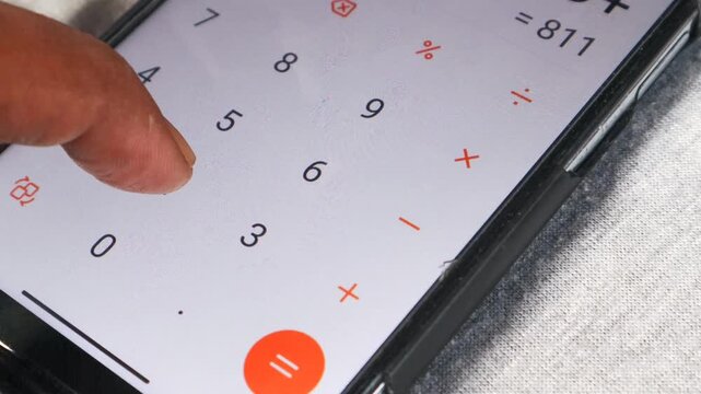 Person counts on a calculator of smartphone. Man counting accounting bills on phone.