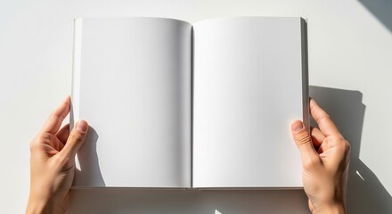 Hands holding an open blank white book with empty pages, illuminated by natural light, providing a clean canvas for creative content, new ideas, or personal journaling
