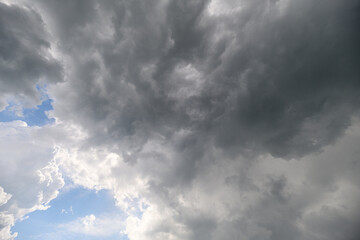 A Dramatic Cloudy Sky adorned with Blue Patches creates a beautiful and serene atmosphere