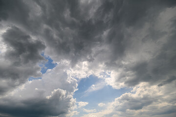 Experience the breathtaking beauty of a dramatic cloudscape with the blue sky peeking through