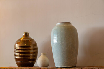 Different ceramic vases on wooden background, The Pottery Gallery.