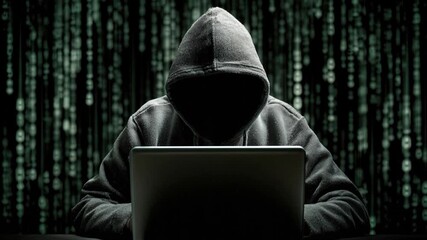 AI generated hooded hacker typing on laptop, immersed in a digital code matrix background, symbolizing cybersecurity threats and data privacy. High-tech video footage. - Powered by Adobe