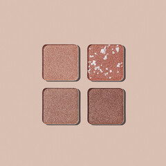 Closeup view Neutral Eyeshadow Palette with Matte and Shimmer, beige brown with golden shimmer shades. Top view of eyeshadow refills, Swatches powder eyeshadow or highlighter, cosmetic beauty, makeup
