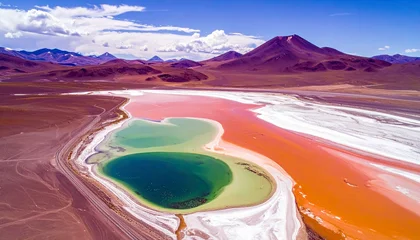 Wandcirkels Paars An aerial shot captures a stunning, multi-colored salt lake with distinct sections of deep green, light green, pink, and orange, set against a backdrop of purpl  © shinta