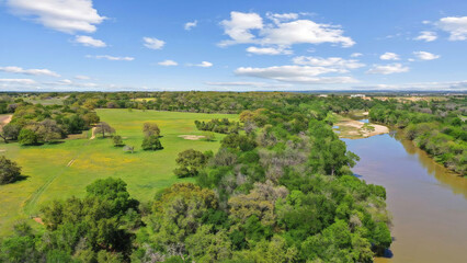 Drone View of River Bend with Open Fields and Tree Line
