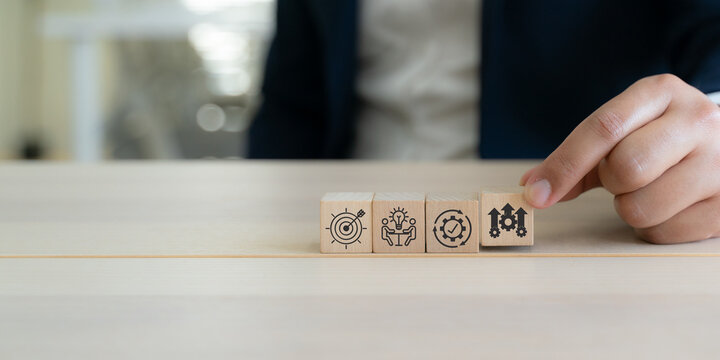 Continuous improvement, productivity growth concept. Wooden blocks with icons for plan, do, check and act for continuous improvement. Continuous improvement, efficiency, rising productivity.