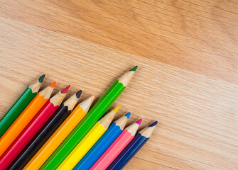 Colored pencils lined up on a wooden surface, Creativity and Colors