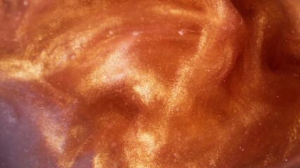 Glitter ink. Vapor art. Defocused golden orange purple color liquid wet shimmer swirling fog floating on abstract glowing background. - Powered by Adobe