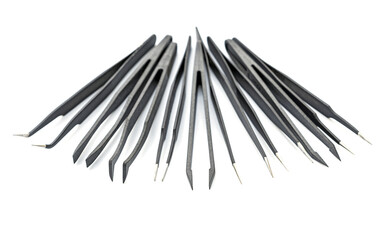 Set of black precision tweezers with metal tips arranged on white background for detailed tasks and crafts