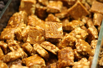 Traditional jaggery gurr and peanut sweet gajak showing Indian winter confection mixture