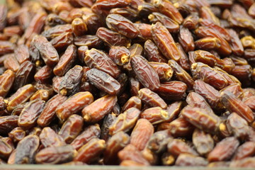 Dried dates fruit texture background showing dark brown khajoor natural sweet closeup pattern
