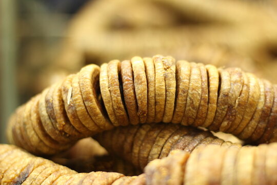 Dried figs texture background showing whole dehydrated anjeer fruit natural brown color closeup