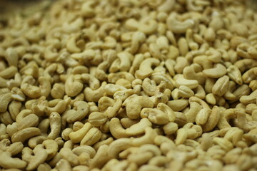 Raw cashew nuts texture background showing whole cream colored kaju natural pattern closeup