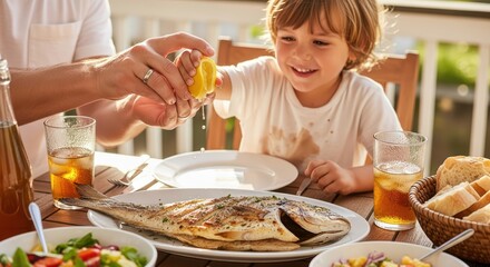 Caucasian child enjoying outdoor family lunch with grilled fish on sunny day
