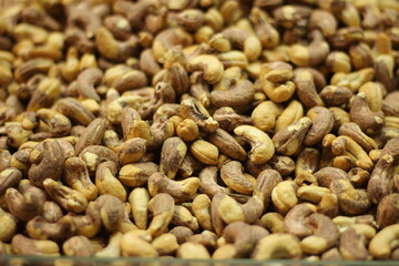 Roasted cashew nuts texture background showing golden brown kaju dry roasted natural closeup