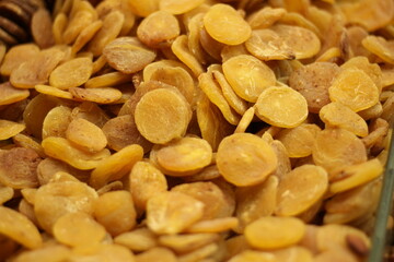Dried apricots pile showing golden orange dehydrated fruit texture and natural sweetness