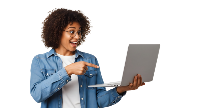 Smiling young African American woman in glasses holding and pointing at a laptop screen with an excited expression showcasing digital content or an online opportunity