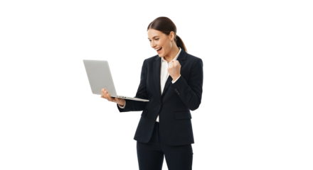Successful young businesswoman in elegant corporate attire holding a sleek modern laptop celebrating a triumph with an excited smile and a triumphant fist pump achieving digital success and