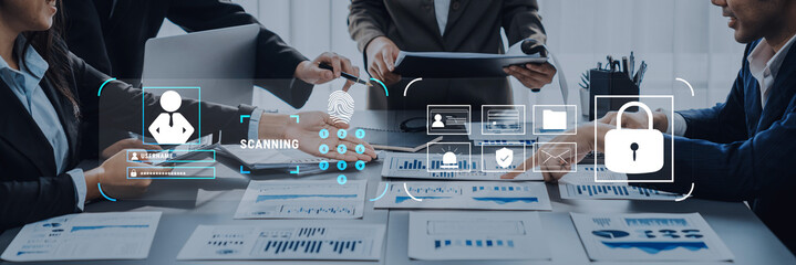 A modern office scene showcasing professionals engaged in document sharing while emphasizing digital security and data analysis. Collaboration and teamwork shine during this business meeting. Trope
