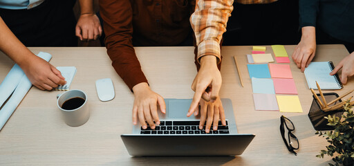 A dynamic office scene demonstrating teamwork, collaboration, and creative brainstorming among...
