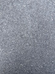 Top view close up of dark grey washed gravel texture or exposed aggregate concrete surface