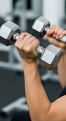 Close-up of Woman Lifting Dumbbells at the Gym for Arm Strength Training