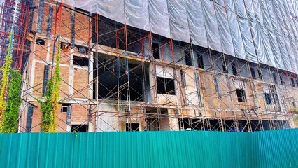 Building Construction Site with Scaffolding and Brick Structure, Hospital under construction