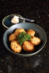 Satsuma age, fried fish dumplings made with potato starch, salt, ginger, and soy sauce, fried in vegetable oil.