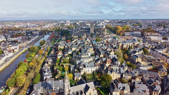 Backward drone fly over Le Mans city skyline with gothic Le Mans Cathedral near Sarthe River, France