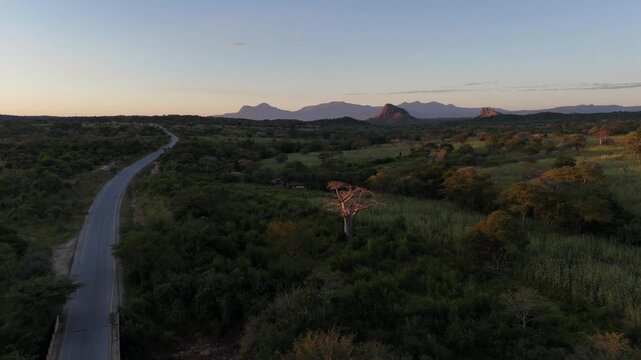Drone aerial of a lonely road crossing vast countryside near Lubango, Angola