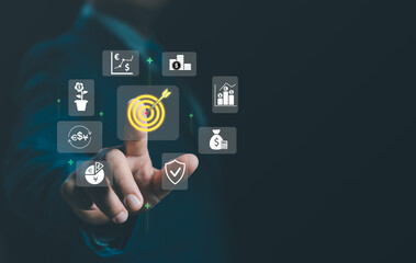 Financial target concept businessman selects digital dartboard surrounded icons investment, currency exchange, growth charts, savings, and financial security, highlighting strategic money management.