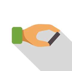 Hand holding a small dark gray rectangular object, possibly a battery or electronic component, casting a long shadow