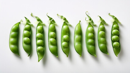 Fresh snap peas arranged neatly on a plain white surface