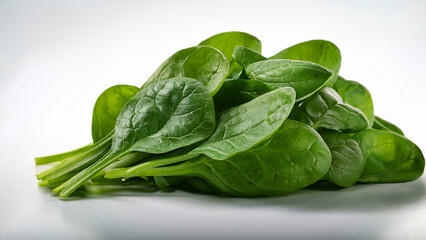 A small stack of fresh spinach leaves arranged neatly on white background
