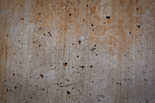 Old concrete texture with holes and stains, Damaged concrete wall with patina and rust color