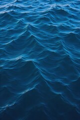 Deep Ocean Water Texture A close up, textured view of deep ocean water. The surface shows subtle ripples and light refractions, hinting at immense depth and a serene, dark blue hue. Focus on the