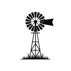 Classic silhouette of a farm windmill with grass