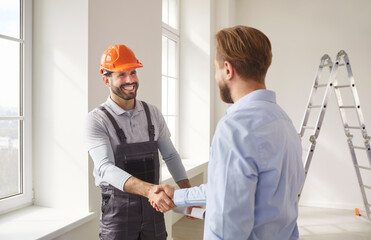 Man client shaking hands with professional architect or engineer, reaching agreement about...