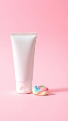 White tube stands by rainbow candy on pink