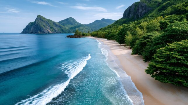 Tropical beach aerial view with ocean waves and green mountains