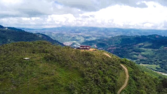 Aerial View of Mountain Ridge with Isolated Building and Winding Dirt Road