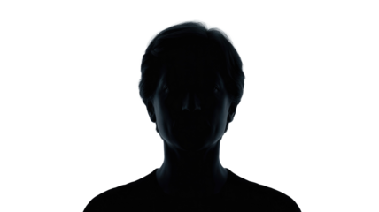 Mysterious silhouette of a person's head and shoulders against a dark transparent background, emphasized by strong backlighting creating a glowing halo effect. background removed