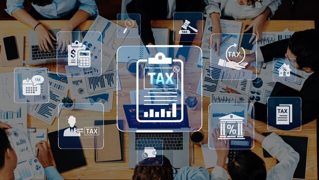 A business team collaborates on tax planning, reviewing financial reports and utilizing technology to analyze data and develop strategies for effective management. Raster