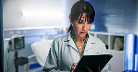 Doctor, woman and tablet for planning in hospital with reading for healthcare or consultation. Typing, support and service with person for diagnosis, medical treatment and results in night clinic