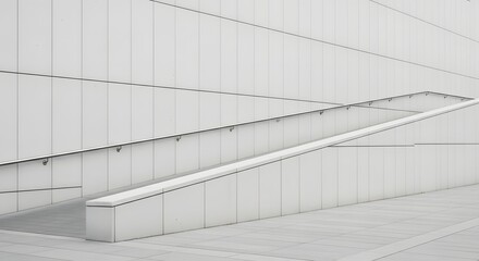 Abstract view of a modern white building exterior featuring an accessibility ramp and geometric tiled walls