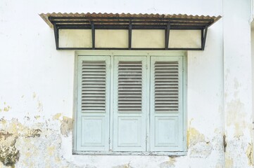 Vintage Wooden Window Shutters on Weathered Wall