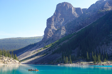 Turquoise glacial lake and glacier covered mountain ridge
