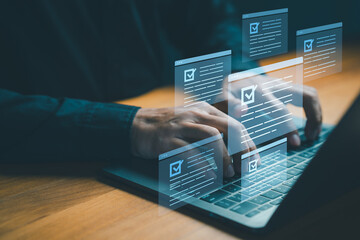 Business person using laptop computer with checklist documents and forms, symbolizing online survey, workflow automation, task management, electronic signature and digital productivity solutions.